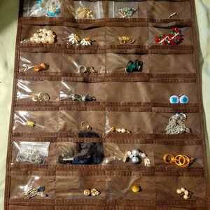 Brown Jewelry Organizer with A Collection Of Clip On And Screw Back Earrings